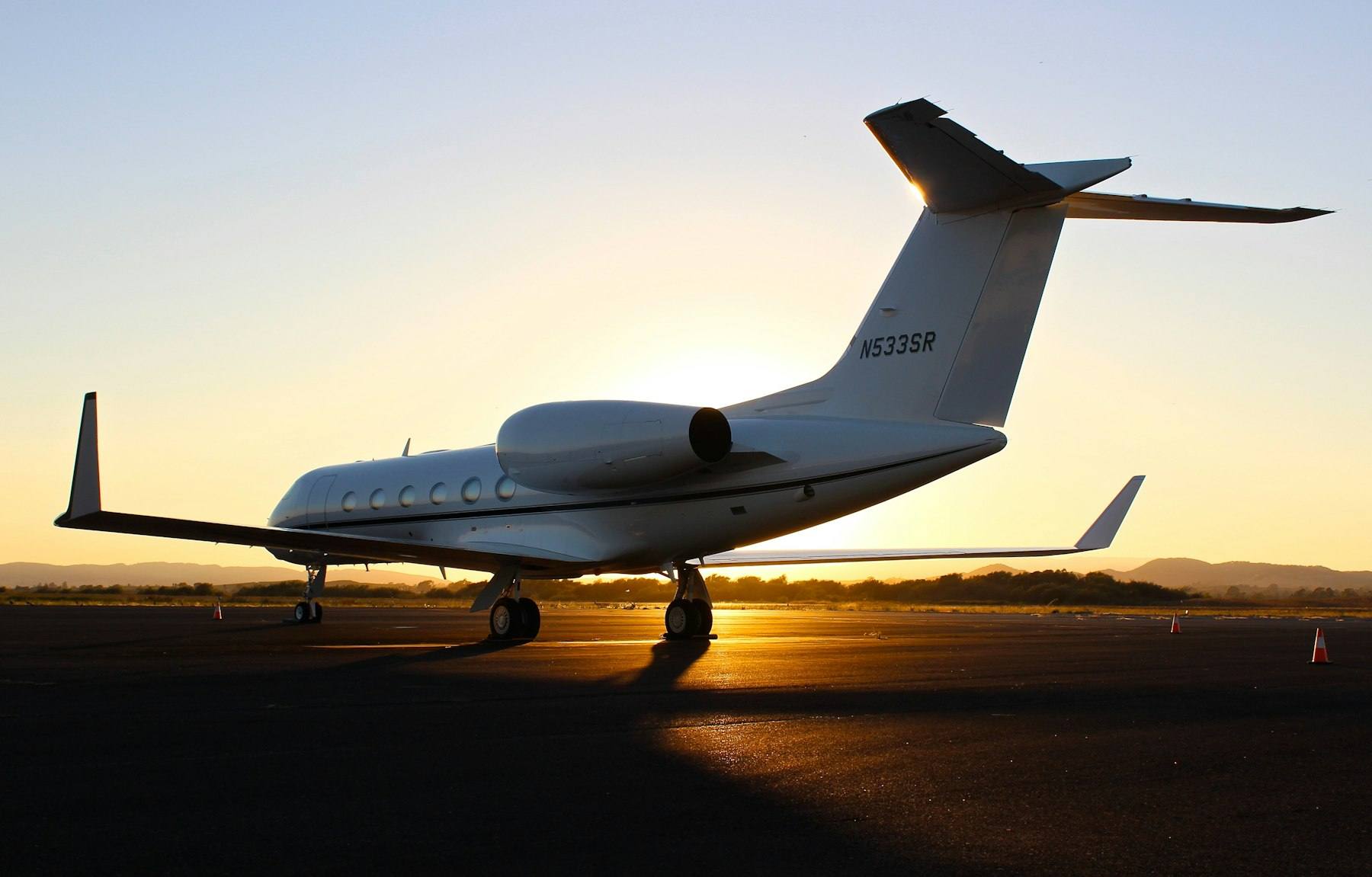 Business jet on the ramp at sunset